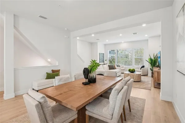 a large white kitchen with stainless steel appliances granite countertop lots of white cabinets a stove and a sink