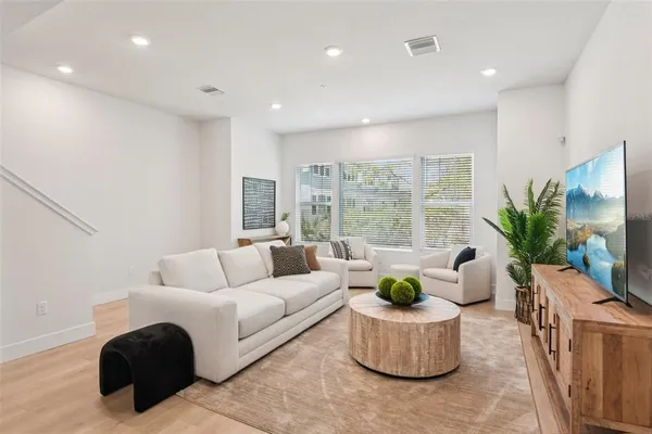 a dining room with furniture and potted plant