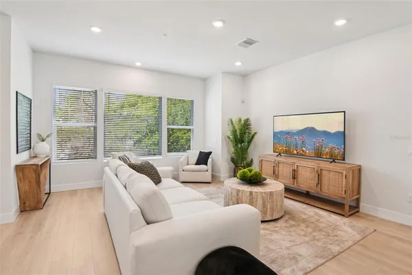 a dining room with furniture and wooden floor