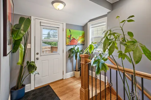 a view of yellow house with a potted plant