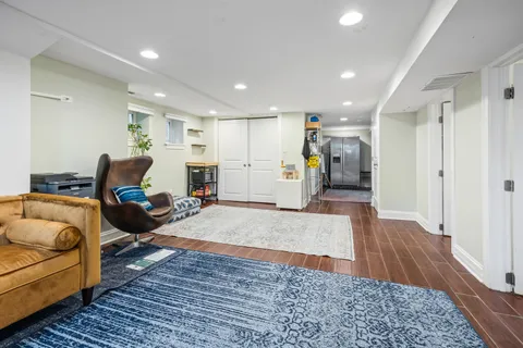 a living room with furniture and a wooden floor