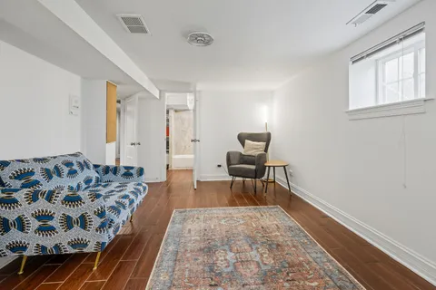 a living room with furniture and a rug
