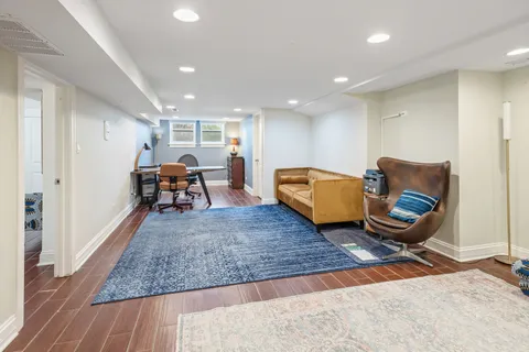 a living room with furniture rug and wooden floor