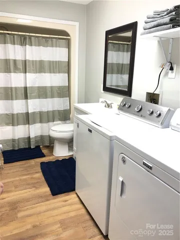a bathroom with a sink toilet and mirror