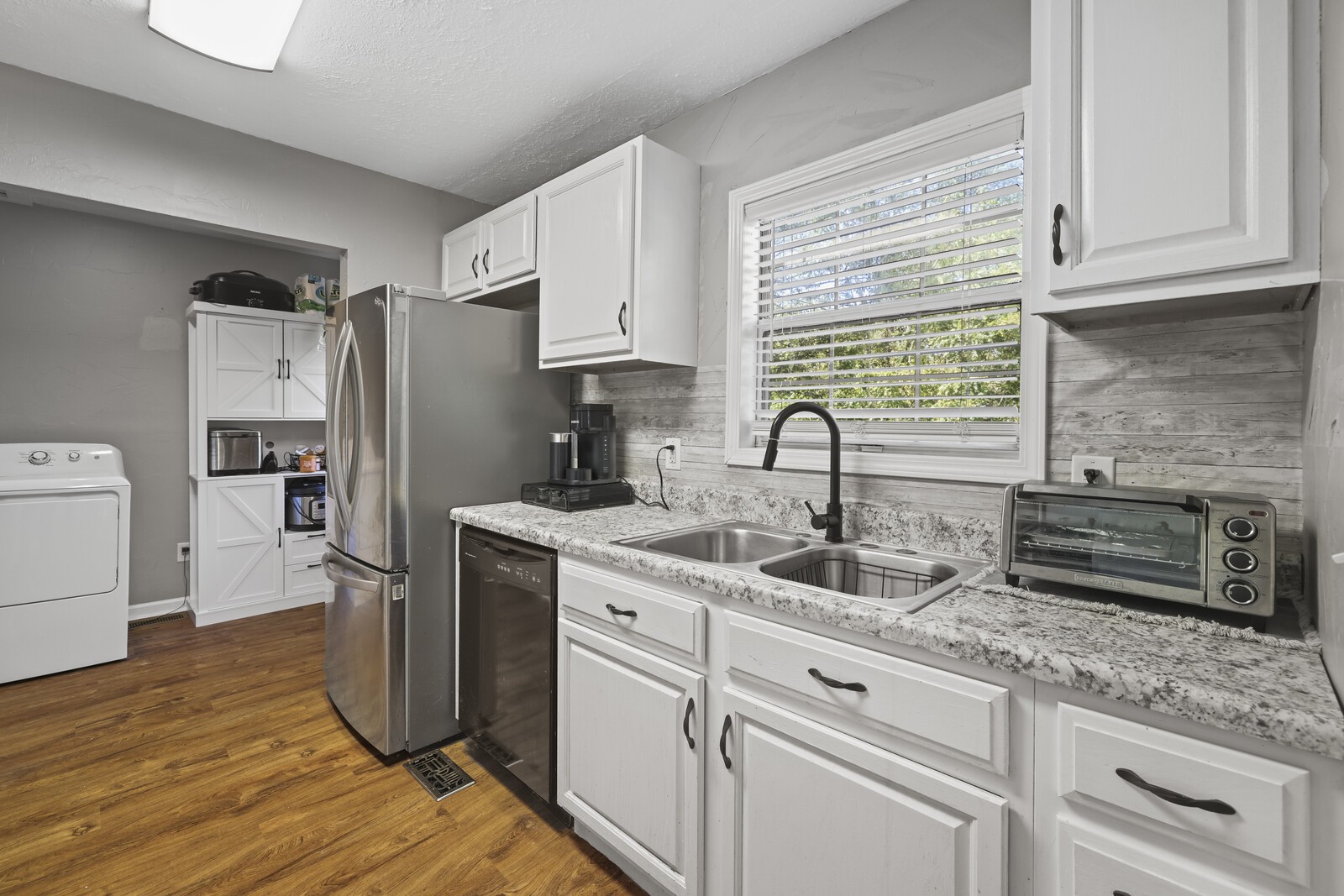 408 Magnolia Street Baxter, TN 38544 - Photo 11 of 44 a kitchen with stainless steel appliances granite countertop a refrigerator sink and cabinets