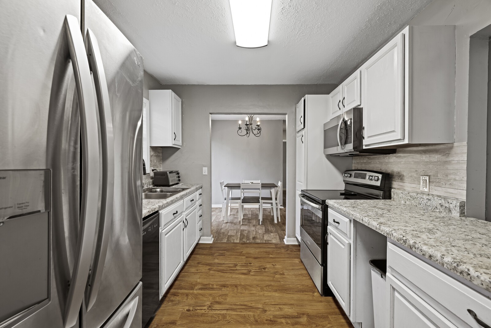 408 Magnolia Street Baxter, TN 38544 - Photo 12 of 44 a kitchen with stainless steel appliances granite countertop a refrigerator a stove and a sink