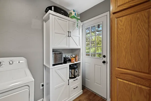 a kitchen with white cabinets and white appliances