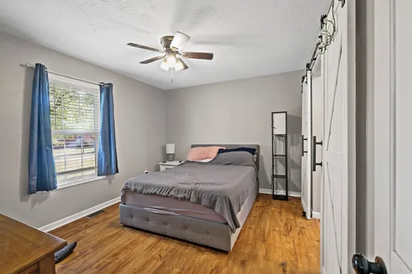 a spacious bedroom with a bed and a window