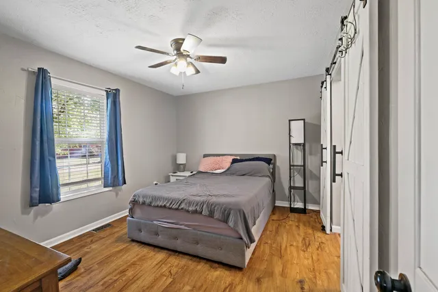 a spacious bedroom with a bed and a window