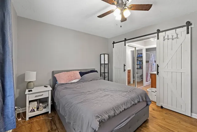 a bedroom with a bed window and a ceiling fan