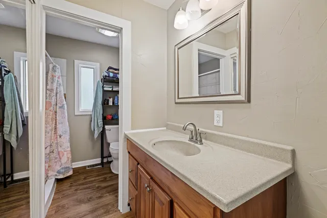 a bathroom with a sink vanity and a mirror