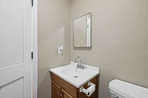 a bathroom with a sink toilet and mirror