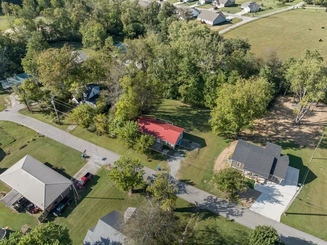 an aerial view of a house with a yard