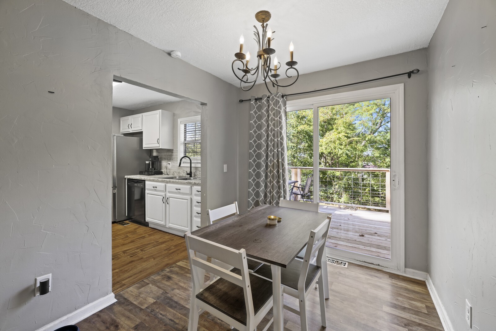 408 Magnolia Street Baxter, TN 38544 - Photo 9 of 44 a dining room with wooden floor a chandelier a wooden table and chairs