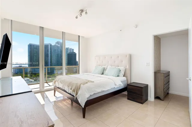 a bedroom with a bed and large mirror