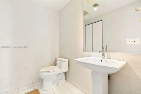 a bathroom with a sink a toilet and mirror