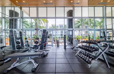 a room with gym equipment and floor to ceiling window