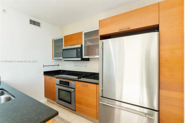 a kitchen with stainless steel appliances a refrigerator and a sink