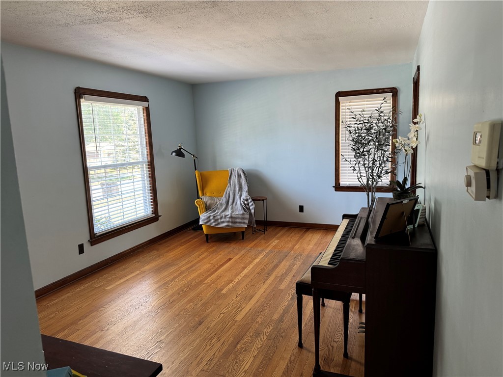 2809 Ralph Avenue Cleveland, OH 44109 - Photo 3 of 35 Livingroom featuring original hardwood floors and a textured ceiling