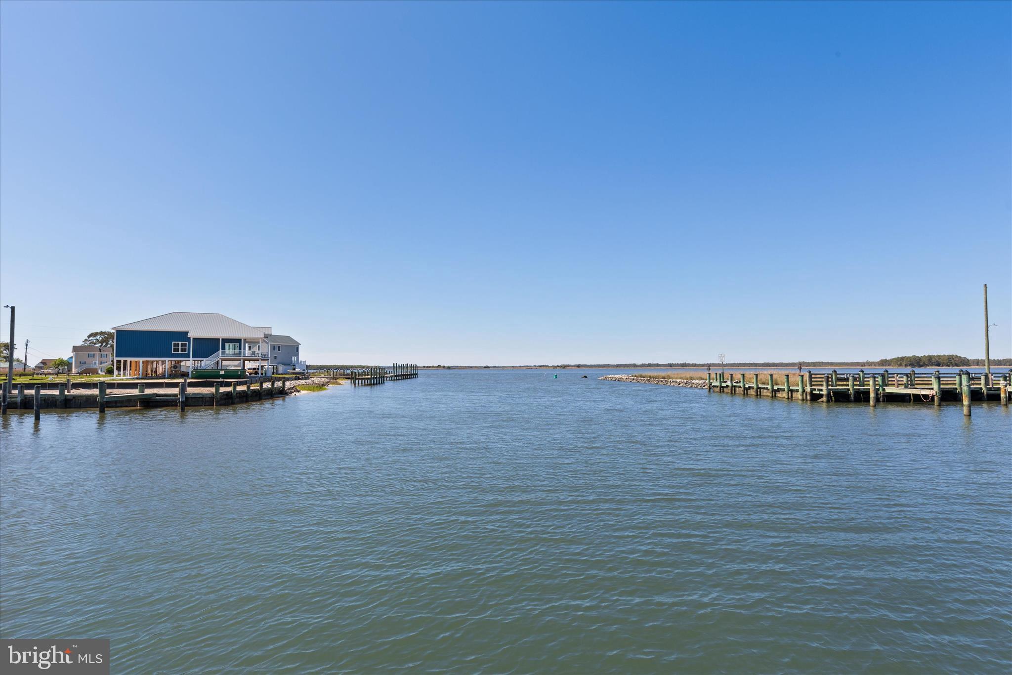 26465 Mason Webster Road Princess Anne, MD 21853 - Photo 41 of 56 a view of an ocean with boats and trees in the background