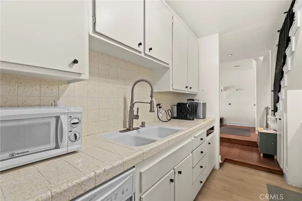 a kitchen with stainless steel appliances a sink a stove and cabinets