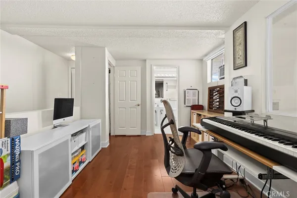 a view of a workspace with furniture and a fireplace