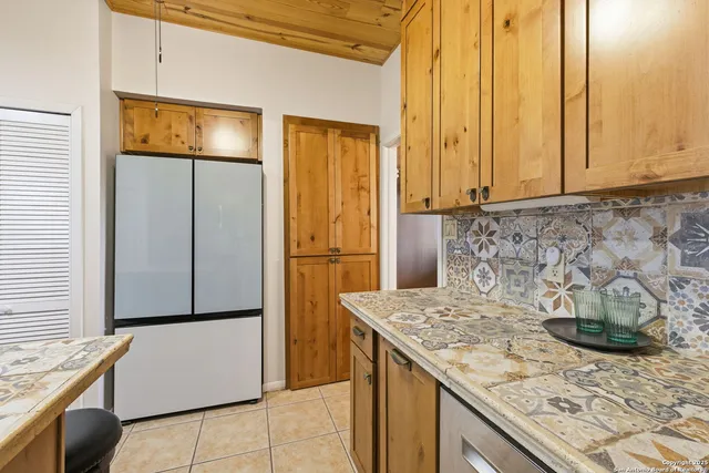 a kitchen with a refrigerator and cabinets