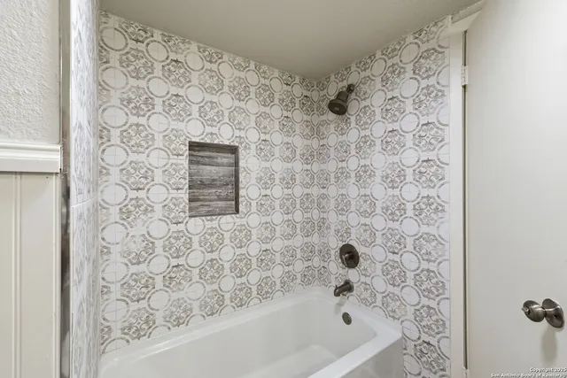 a bathroom with a bathtub and shower