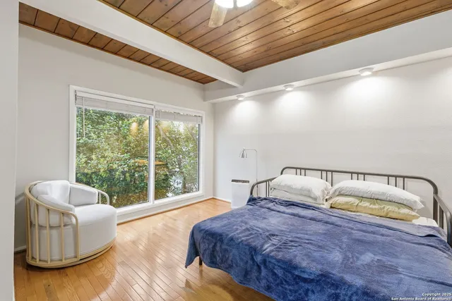 a bedroom with bed and balcony