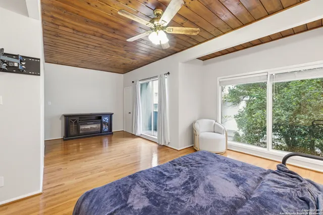 a bedroom with furniture and a large window
