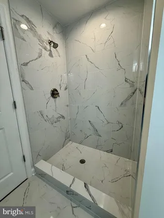 a bathroom with a bathtub and shower