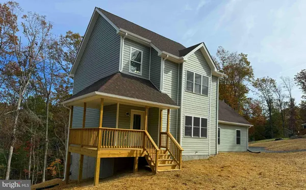 a kitchen with stainless steel appliances granite countertop a refrigerator a stove top oven a sink and dishwasher with wooden floor