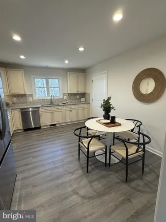 a kitchen with a table and chairs in it