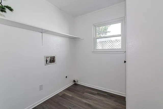 a view of a small space with wooden floor and a window