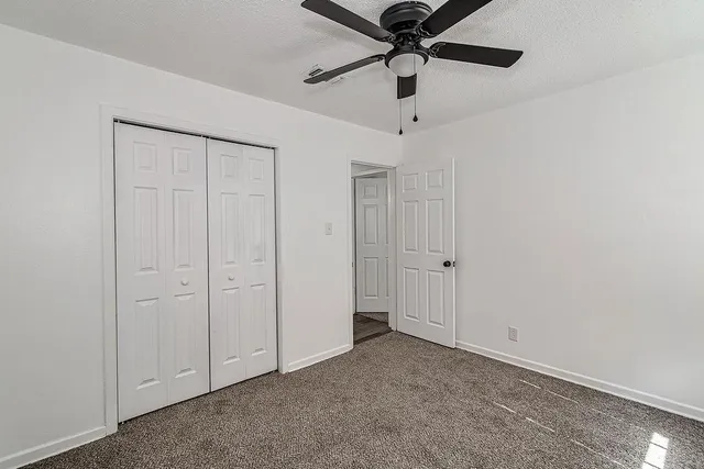 an empty room with a ceiling fan