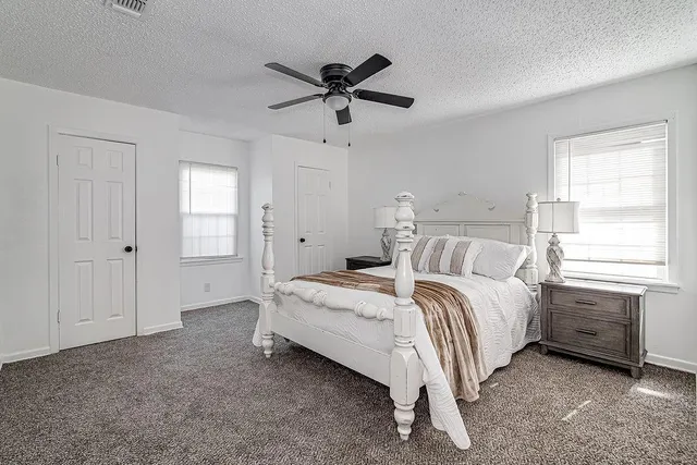 a bed room with a bed and a window