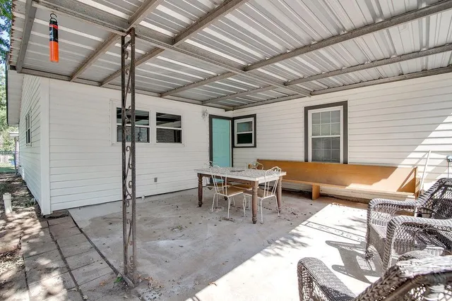 a backyard of a house with outdoor seating