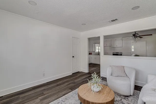 a living room with furniture and a dining table