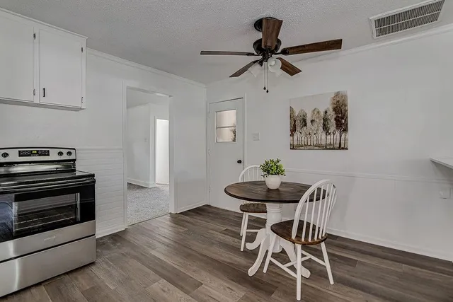 a view of a dining room with furniture and wooden floor
