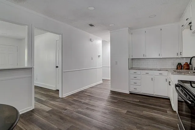 a view of a kitchen with wooden floor