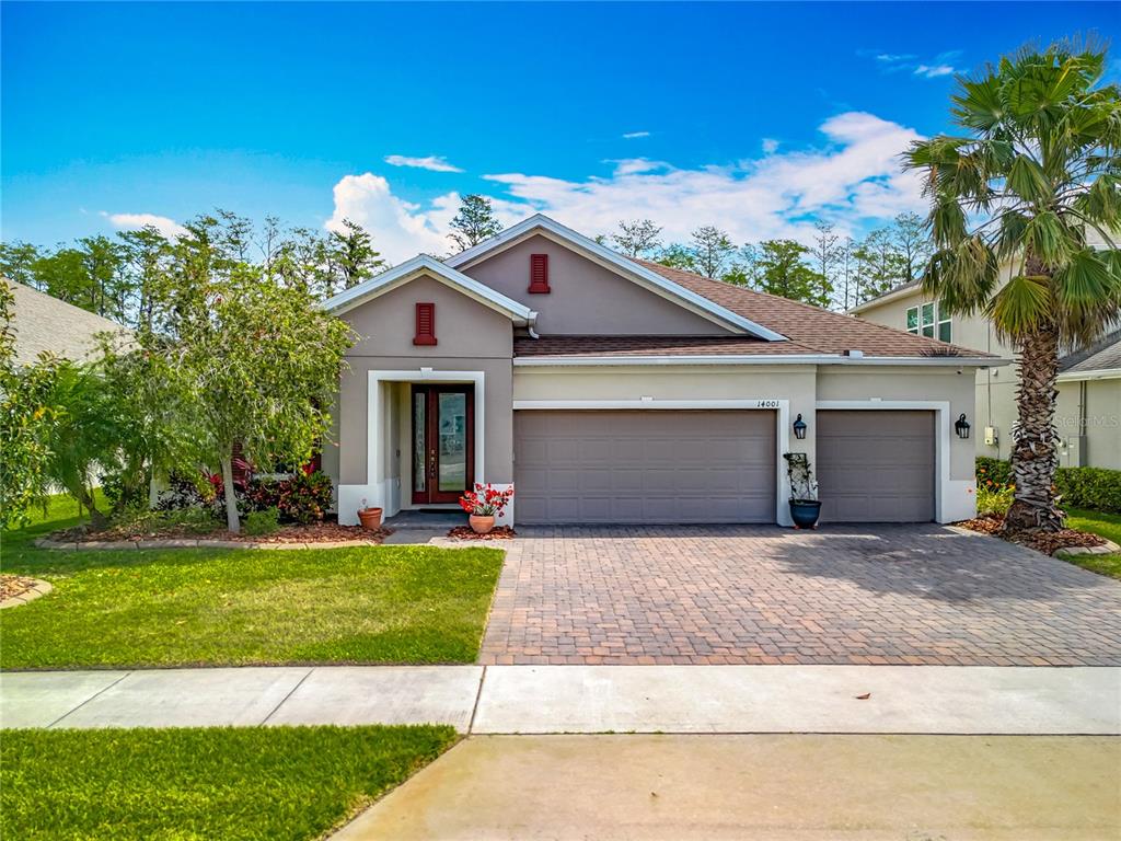 a front view of a house with a yard and garage