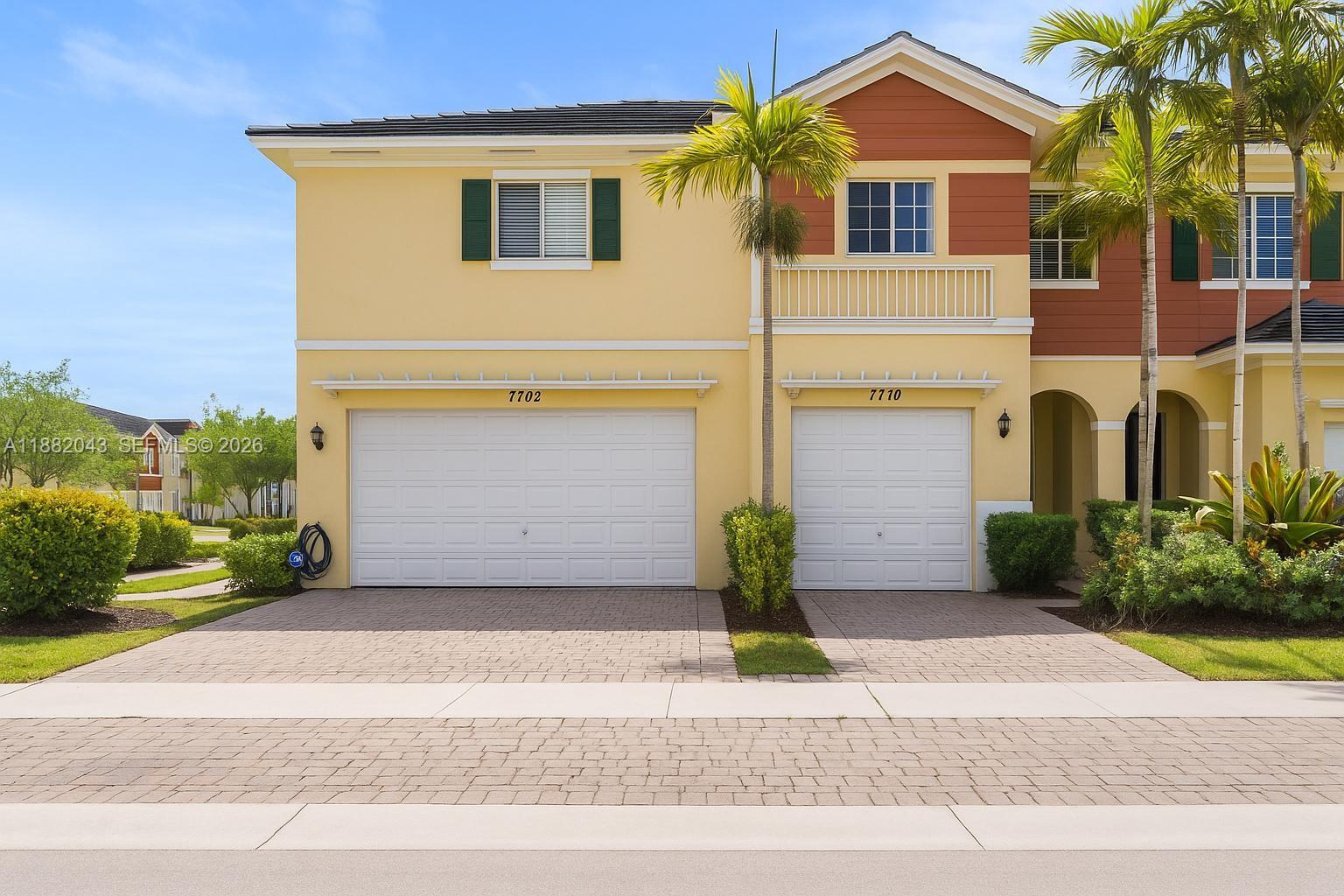 7702 Paddock Place, Unit 7702 Davie, FL 33328 - Photo 1 of 55 a front view of a house with a garden and plants