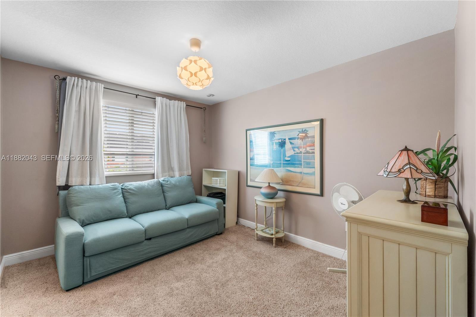 7702 Paddock Place, Unit 7702 Davie, FL 33328 - Photo 11 of 55 a living room with furniture and a large window