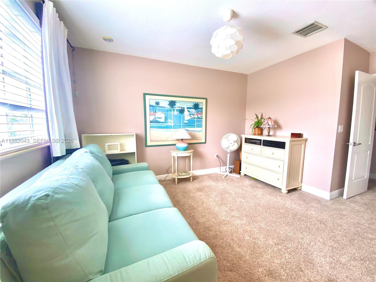 7702 Paddock Place, Unit 7702 Davie, FL 33328 - Photo 12 of 55 a living room with furniture and a window