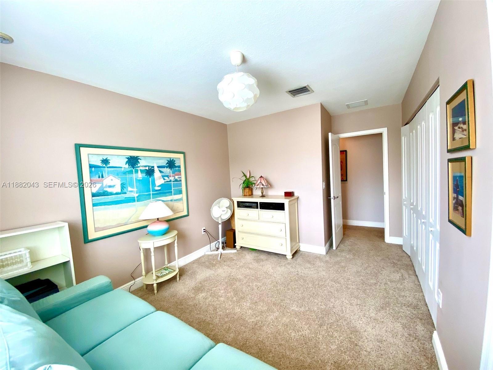 7702 Paddock Place, Unit 7702 Davie, FL 33328 - Photo 13 of 55 a living room with furniture and a flat screen tv