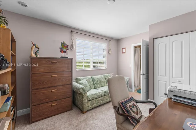 a bedroom with bed and a flat screen tv
