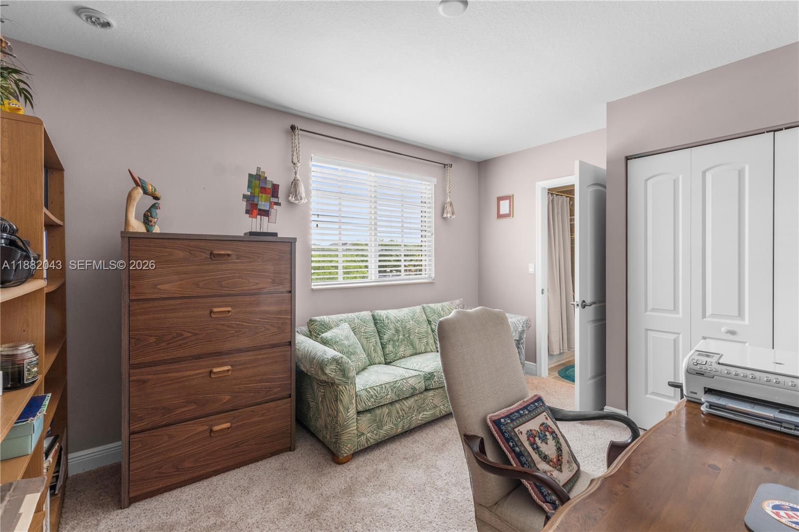 7702 Paddock Place, Unit 7702 Davie, FL 33328 - Photo 16 of 55 a living room with furniture and a window