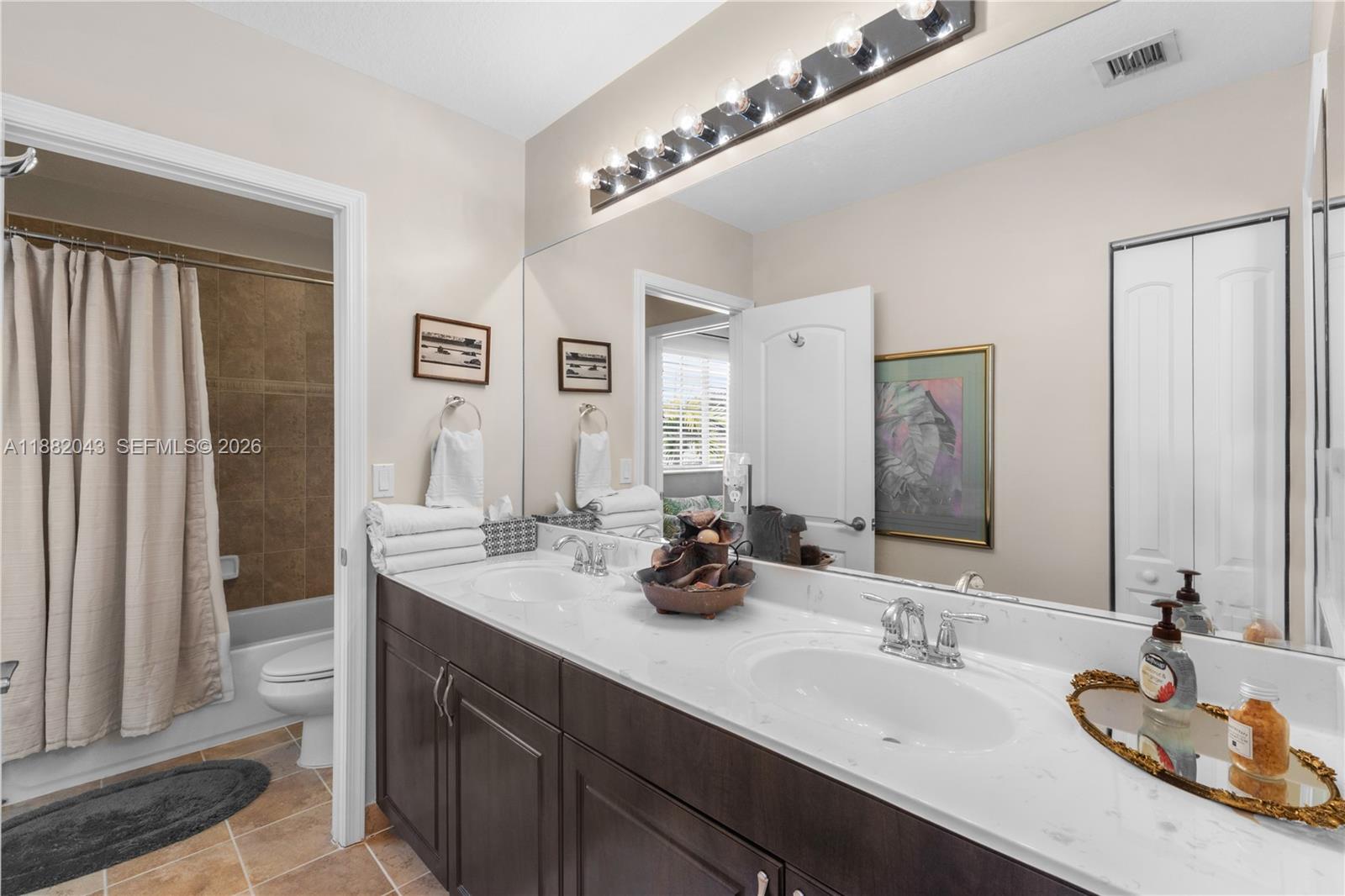 7702 Paddock Place, Unit 7702 Davie, FL 33328 - Photo 19 of 55 a bathroom with double vanity sinks and a mirror