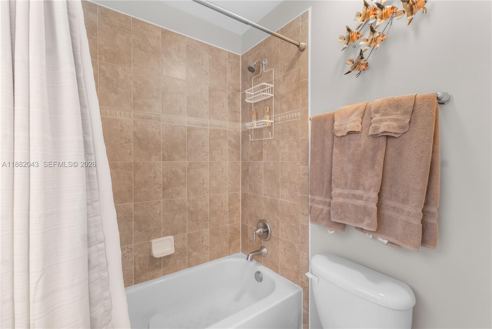 7702 Paddock Place, Unit 7702 Davie, FL 33328 - Photo 21 of 55 a bathroom with a shower curtain and a sink