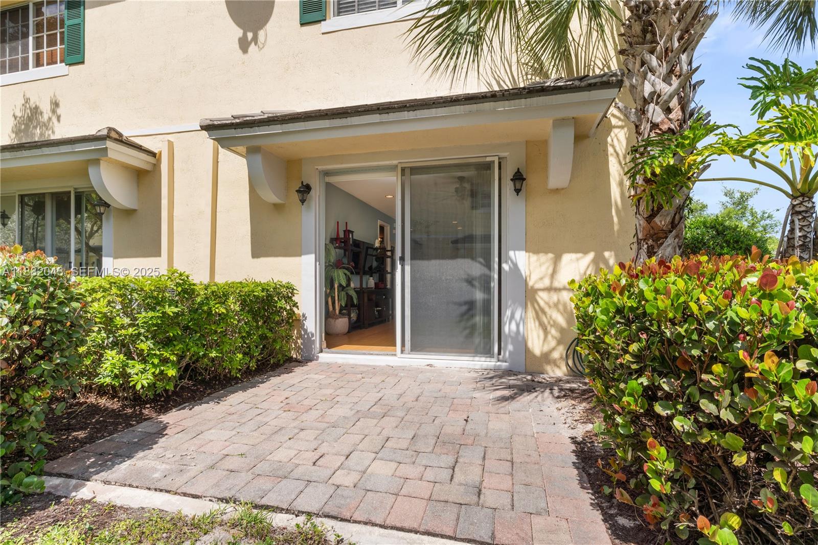 7702 Paddock Place, Unit 7702 Davie, FL 33328 - Photo 23 of 55 a front view of a house with a garden